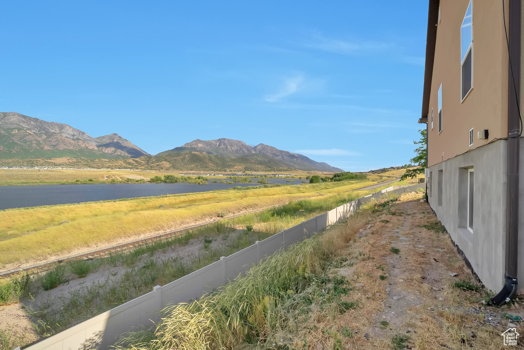 Mountain view featuring a large body of water and rural landscape
