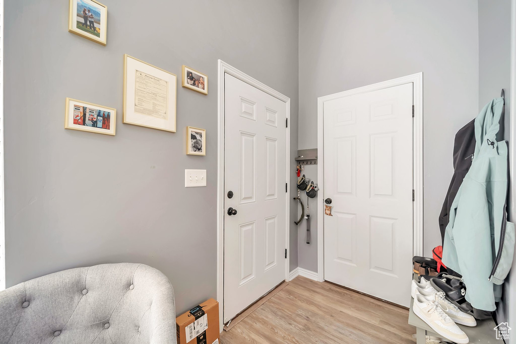 Entrance foyer with light wood-style floors and baseboards