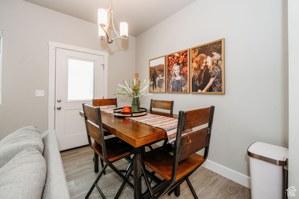 Dining area with a chandelier and light wood finished floors