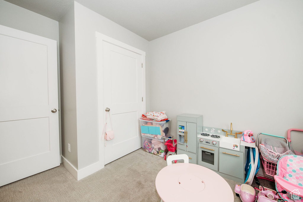 Rec room featuring carpet flooring and baseboards