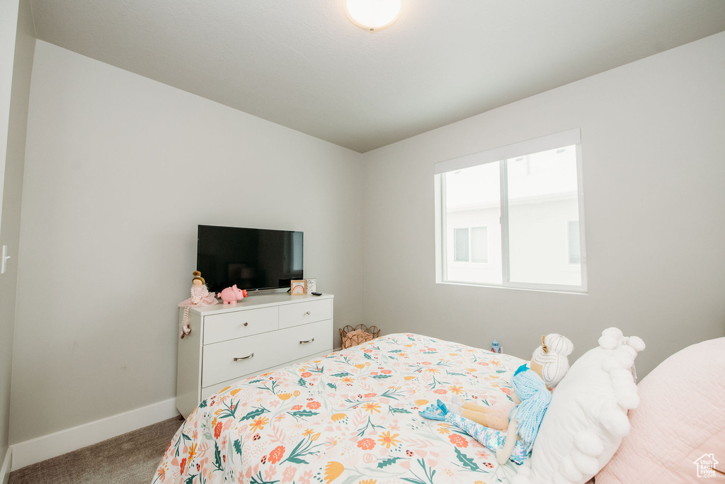 Carpeted bedroom featuring baseboards