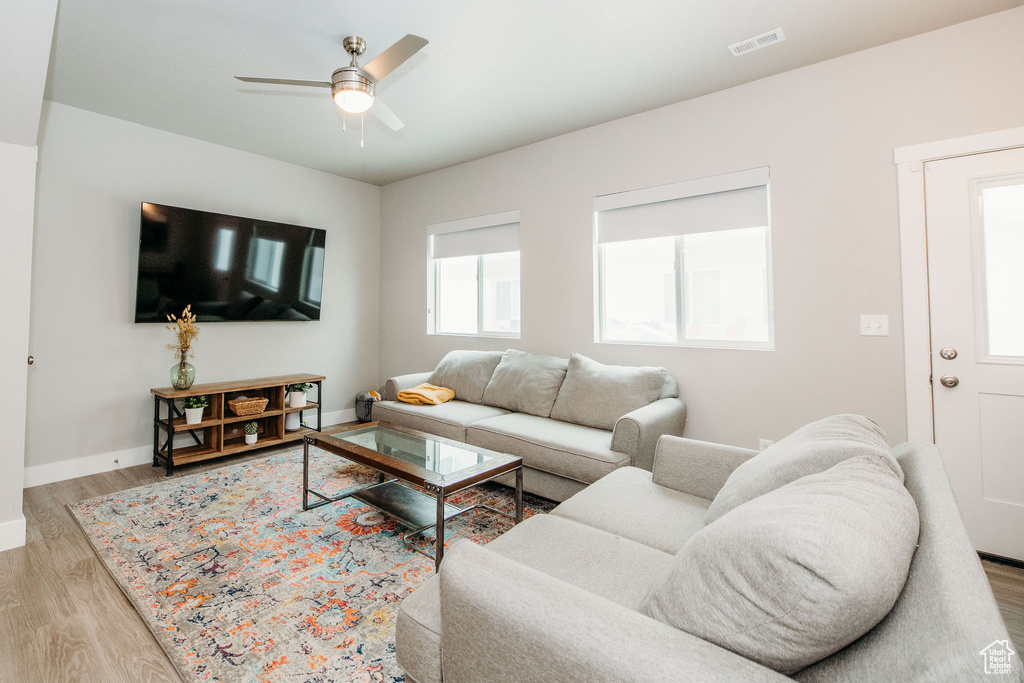 Living area featuring wood finished floors and a ceiling fan