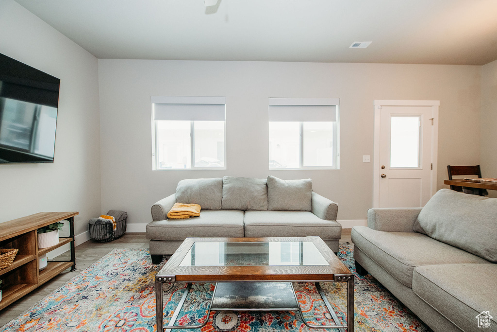 Living area featuring baseboards and a ceiling fan