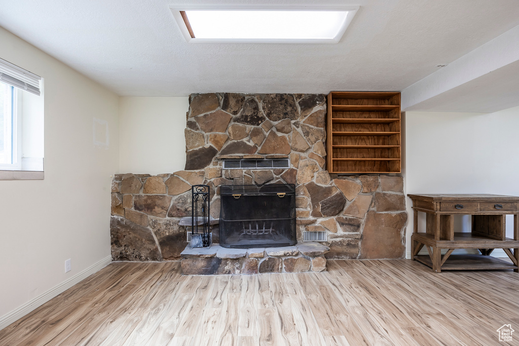 Detailed view of wood finished floors and a fireplace