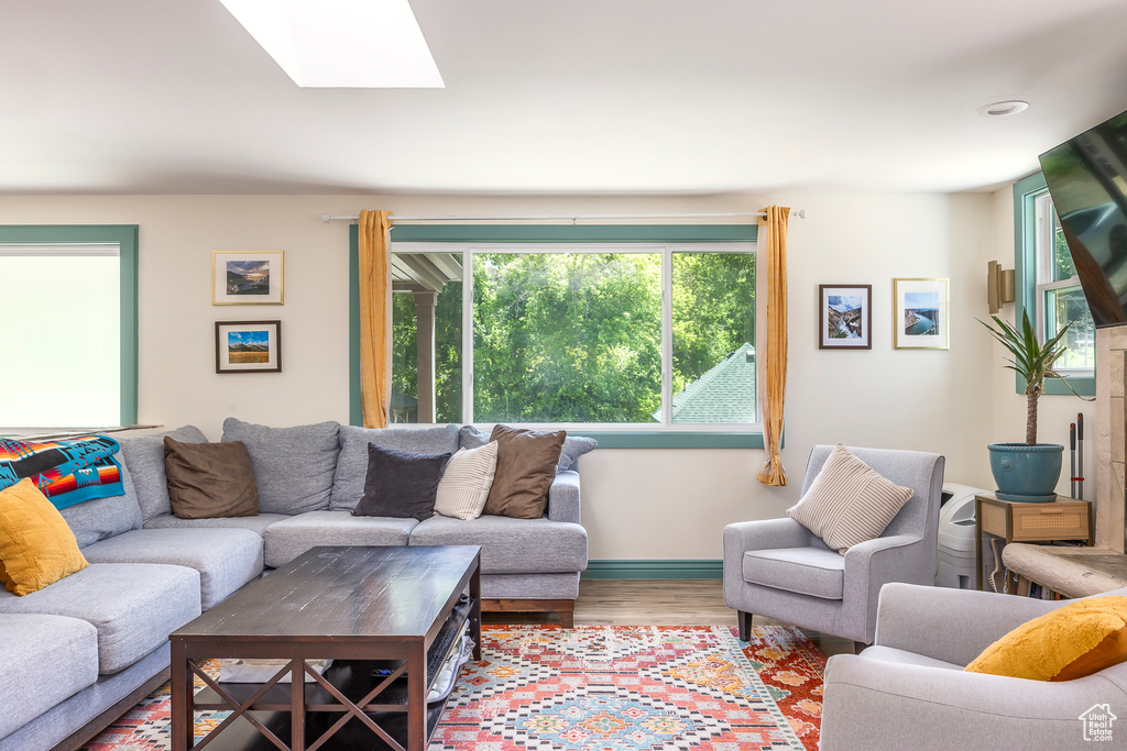 Living area featuring a skylight and wood finished floors