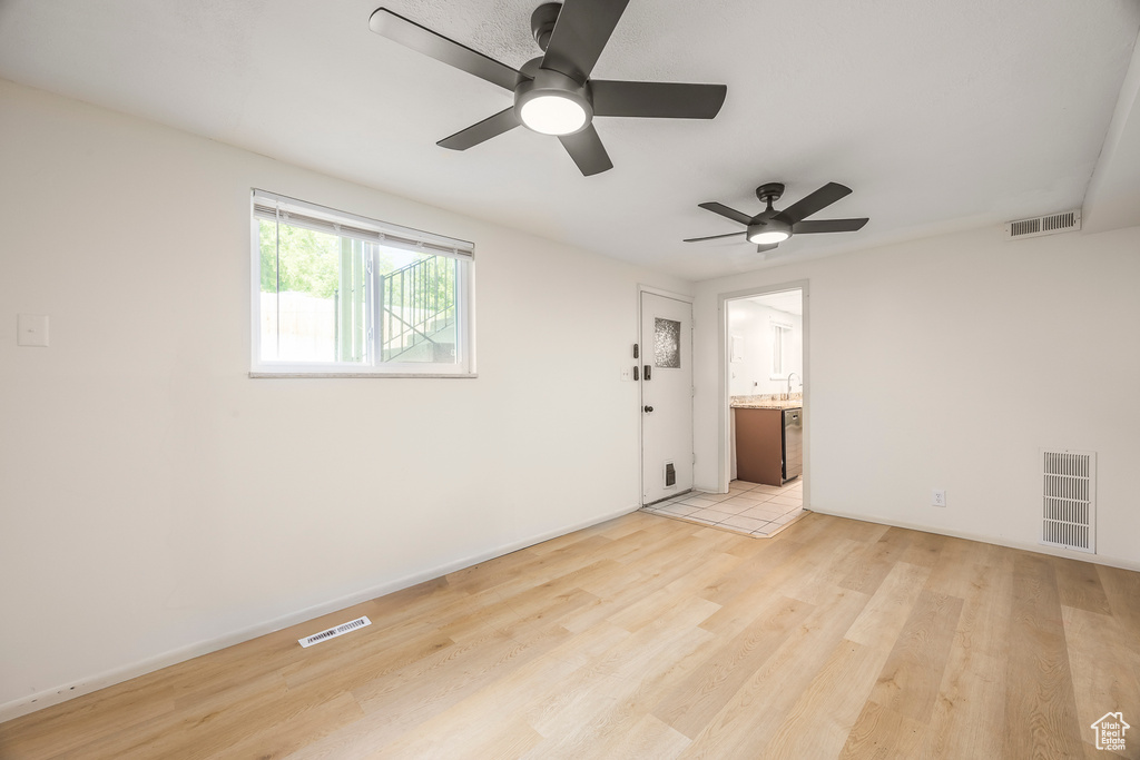 Unfurnished room with a ceiling fan and light wood finished floors