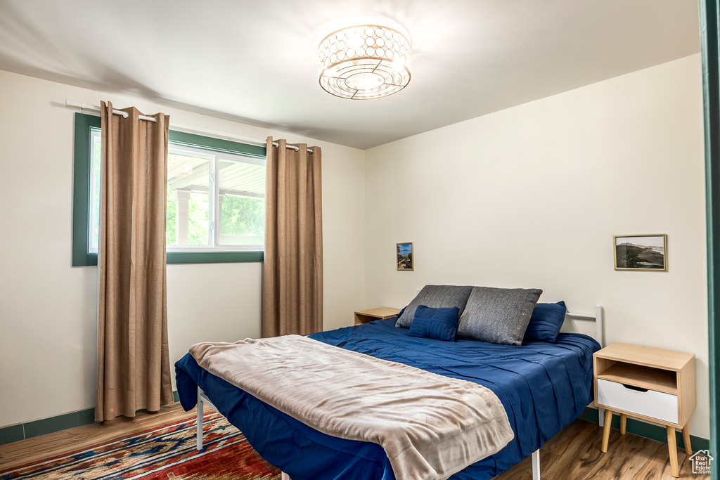 Bedroom featuring wood finished floors and baseboards