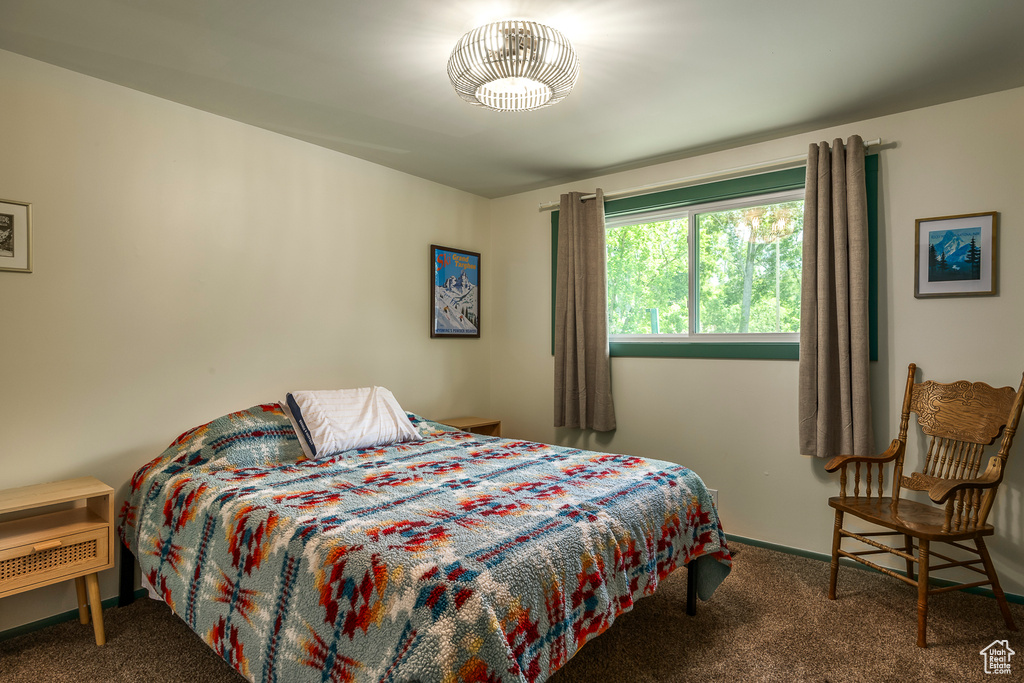 Carpeted bedroom featuring baseboards