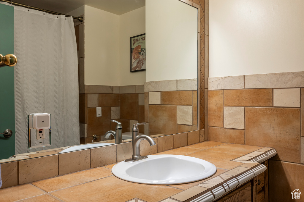 Full bathroom featuring vanity and a shower with curtain