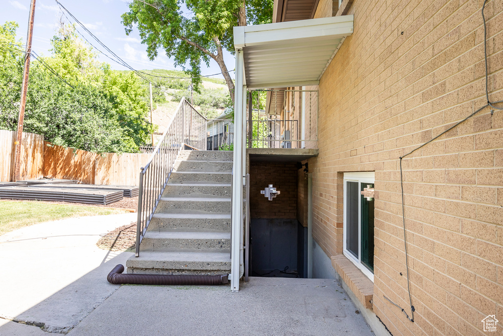 Entrance to property featuring brick siding