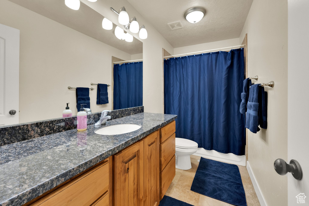 Full bath with vanity and a shower with shower curtain