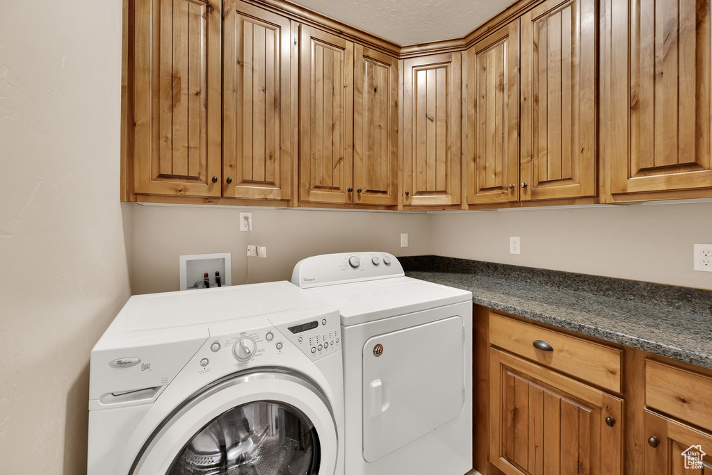 Laundry area with cabinet space and independent washer and dryer