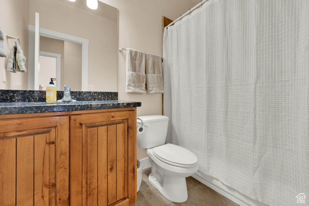 Full bath featuring vanity, tile patterned floors, and curtained shower