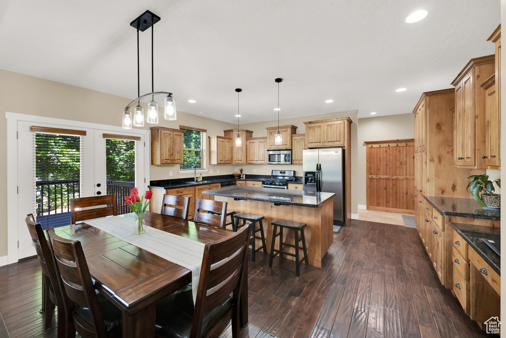 Dining space with dark wood-type flooring, recessed lighting, and french doors