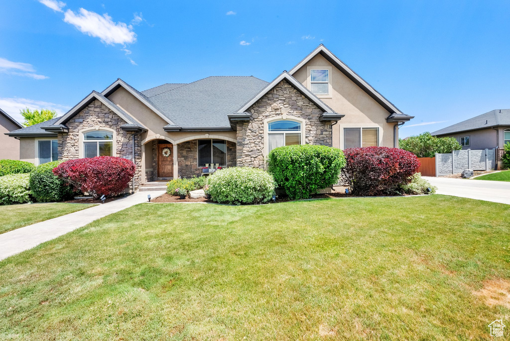 Craftsman-style home featuring stone siding and stucco siding