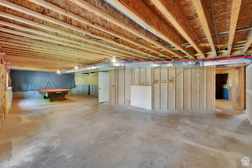 Unfinished below grade area with pool table