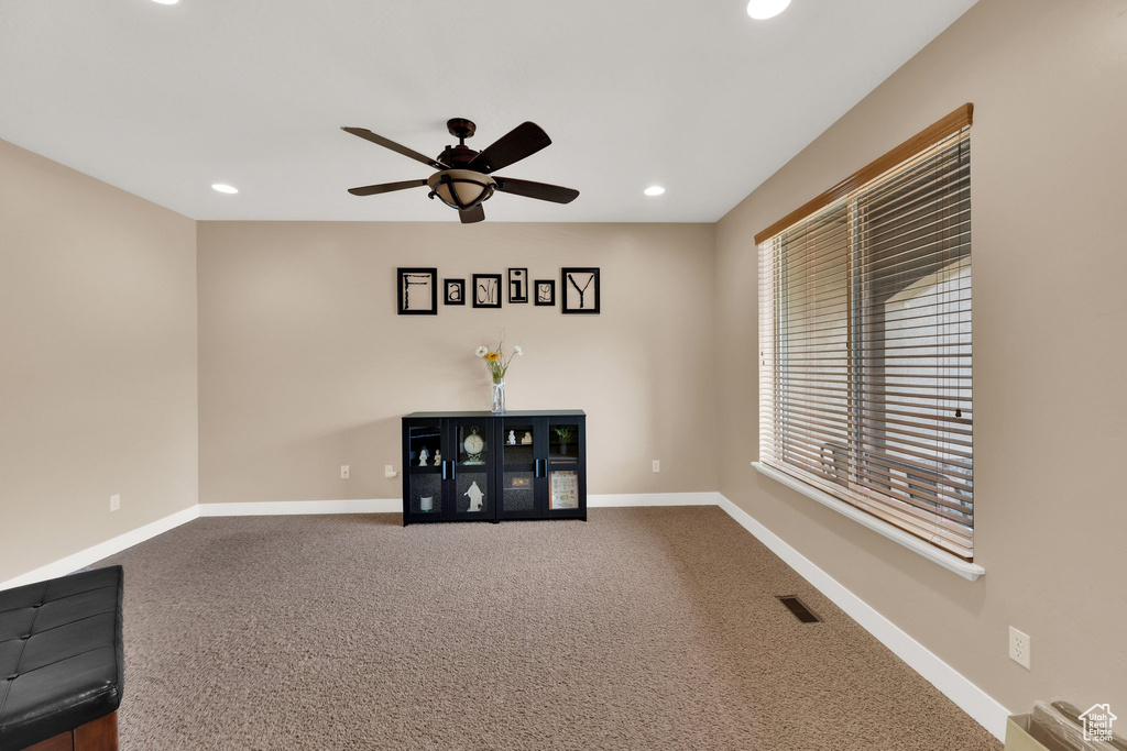 Unfurnished room featuring ceiling fan, recessed lighting, and dark carpet