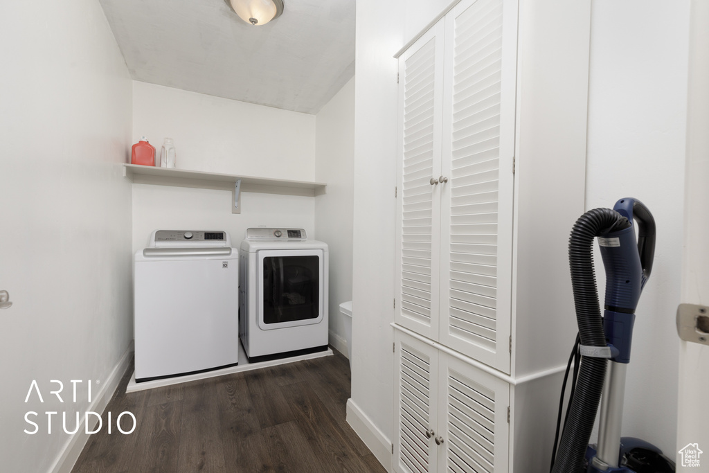 Laundry room featuring separate washer and dryer and dark wood-type flooring