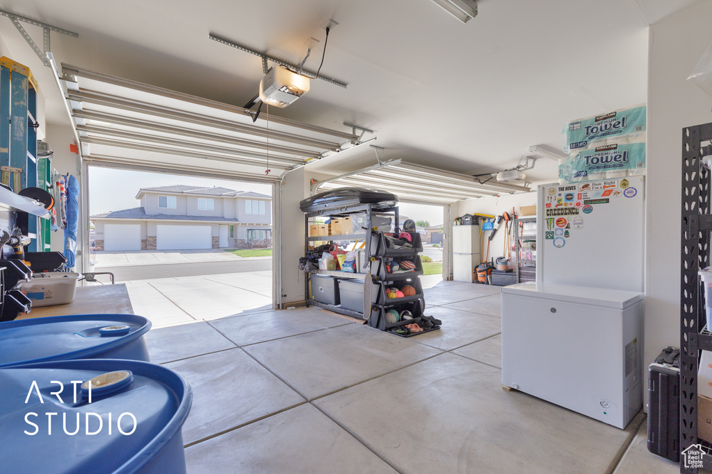 Garage with a garage door opener and refrigerator