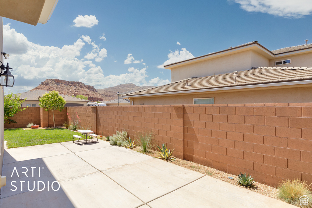 Fenced backyard with a patio and a mountain view