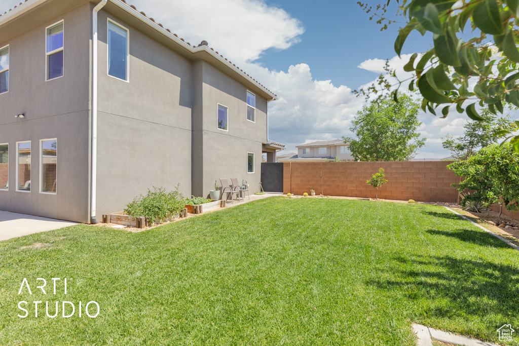 Fenced backyard with a patio area