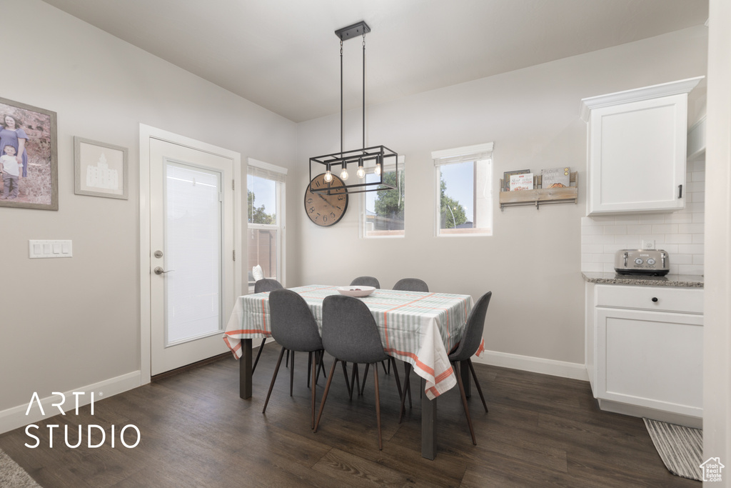 Dining area with dark wood finished floors and baseboards