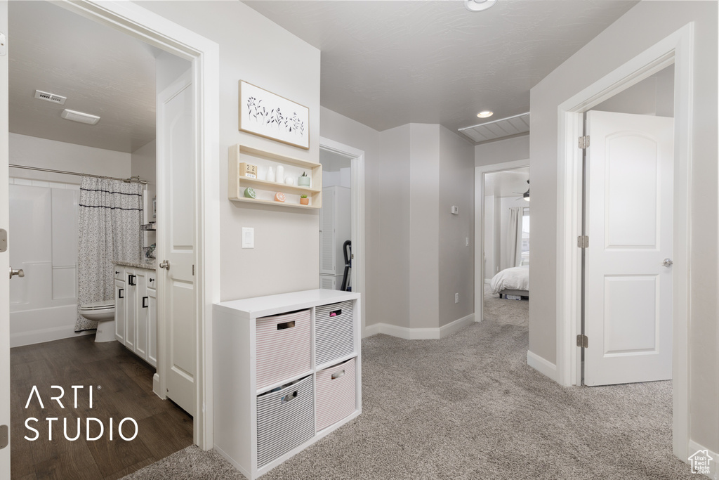 Corridor with dark carpet and recessed lighting
