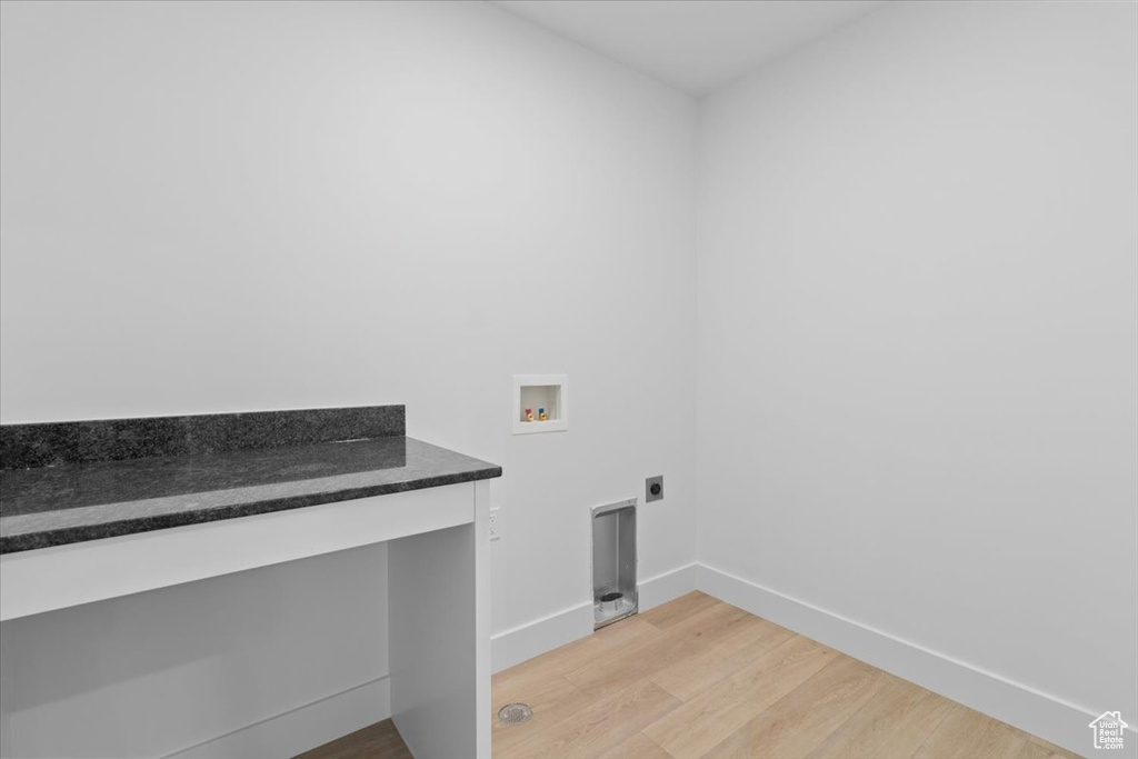 Washroom featuring washer hookup, electric dryer hookup, and light wood finished floors