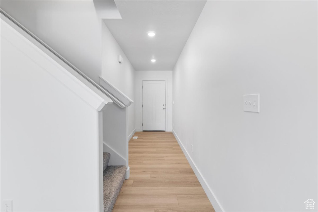 Hall with stairway, light wood-type flooring, and recessed lighting