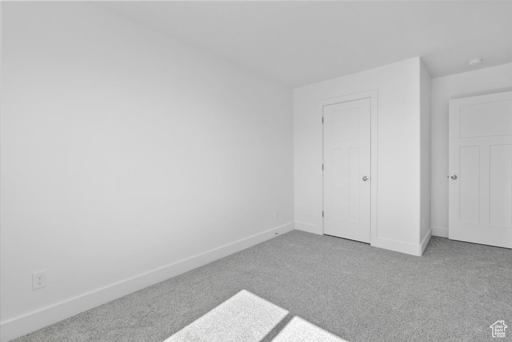 Unfurnished bedroom with carpet floors