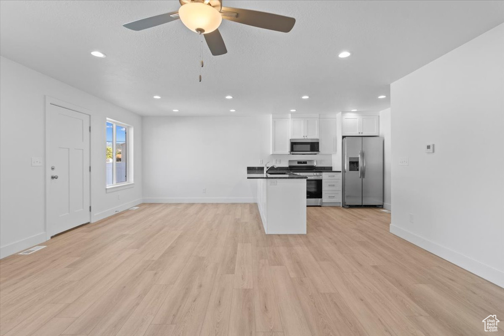 Unfurnished living room with recessed lighting, light wood finished floors, and ceiling fan