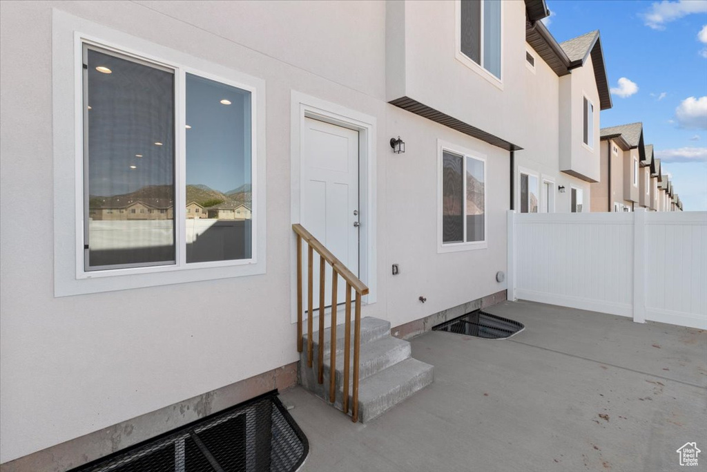 Doorway to property with a patio and stucco siding