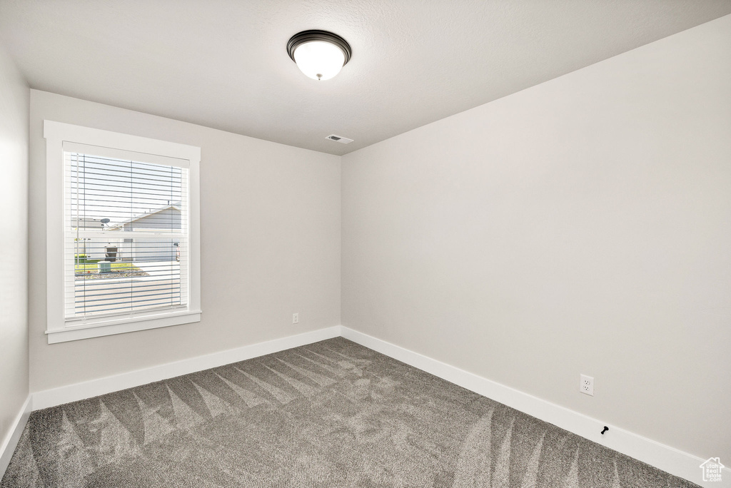 Unfurnished room featuring carpet flooring and baseboards