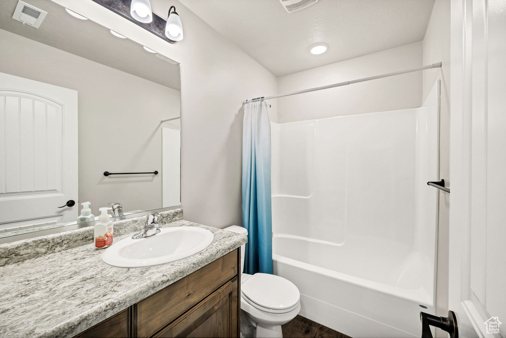 Bathroom featuring vanity and shower / bath combo