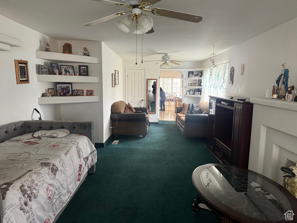 Bedroom with dark carpet and ceiling fan