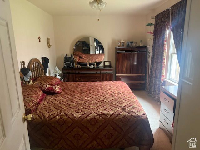 Bedroom featuring light carpet