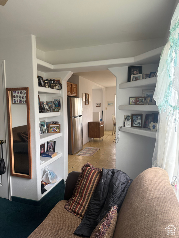 Bedroom with freestanding refrigerator