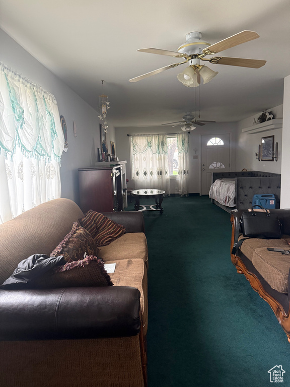 Carpeted living room with ceiling fan