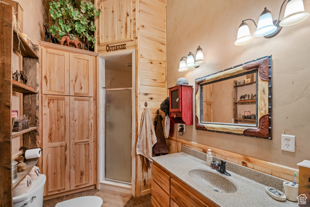 Bathroom featuring vanity, a shower stall, and tile patterned flooring