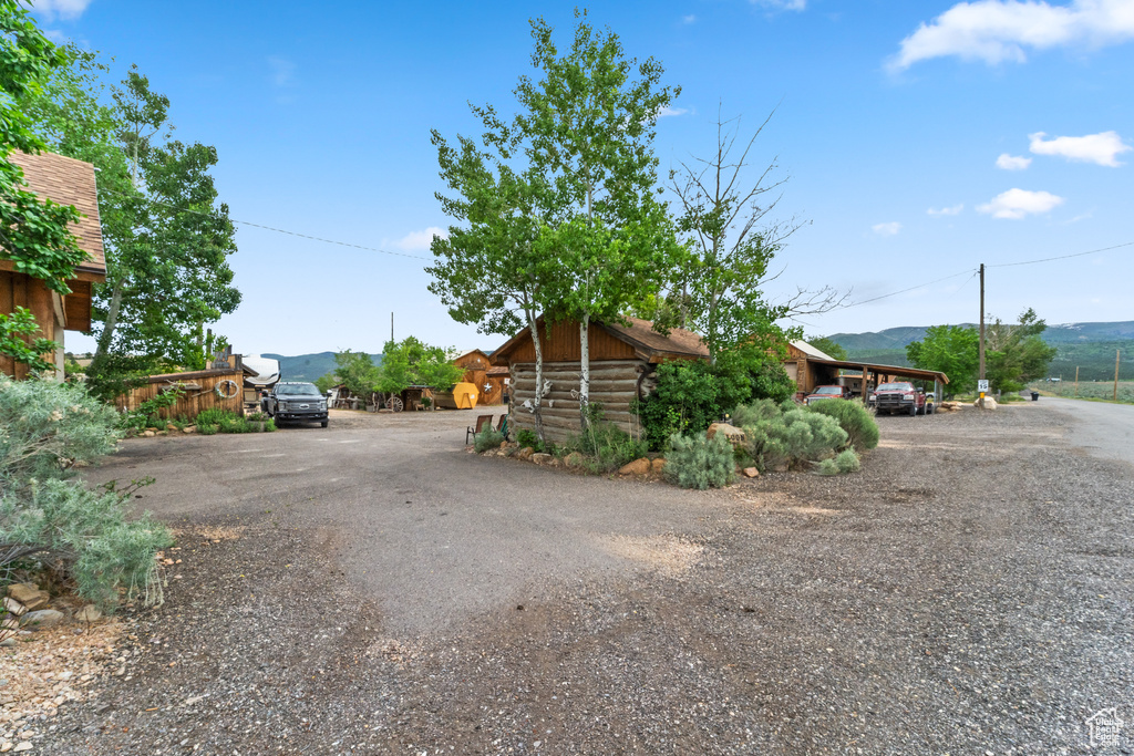 Exterior space with driveway, log exterior, and a mountain view