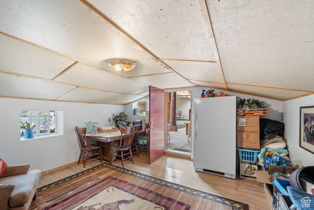 Dining room featuring wood finished floors and lofted ceiling