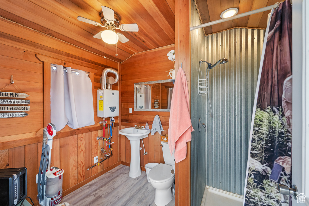 Full bath with wood walls, wood finished floors, a shower, ceiling fan, and wooden ceiling