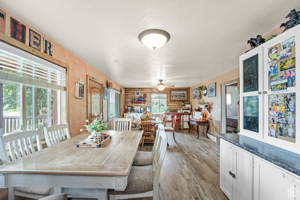 Dining space with light wood finished floors and ceiling fan