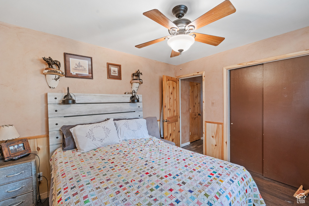 Bedroom with wood finished floors, a closet, and ceiling fan