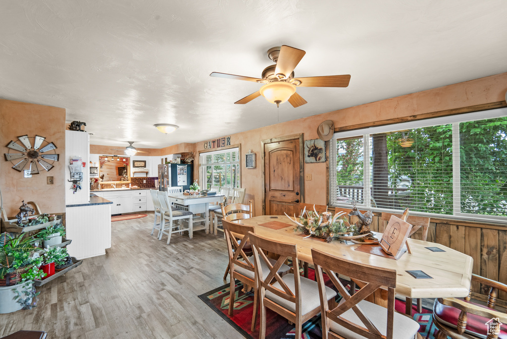 Dining room with ceiling fan and light wood finished floors