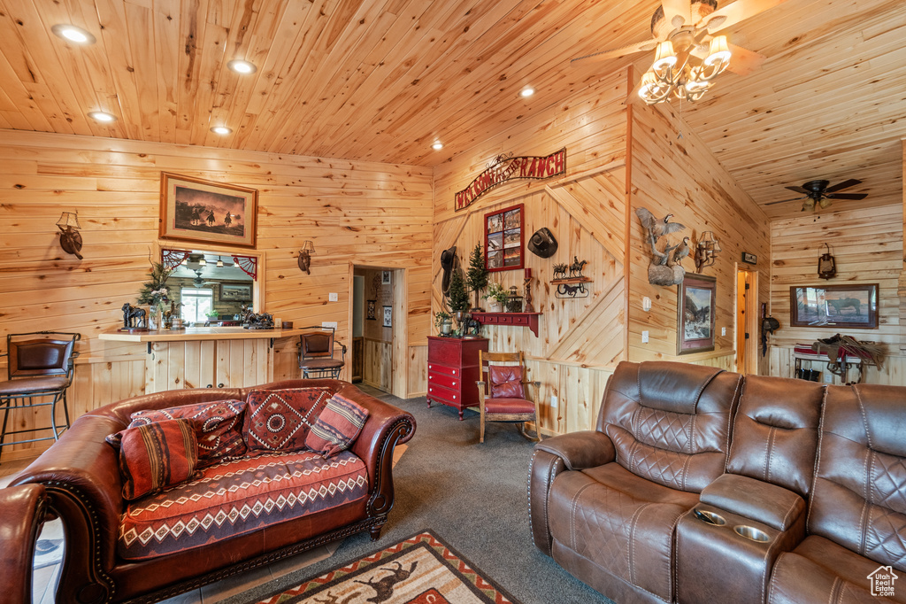Living room with carpet, ceiling fan, wood walls, wood ceiling, and recessed lighting
