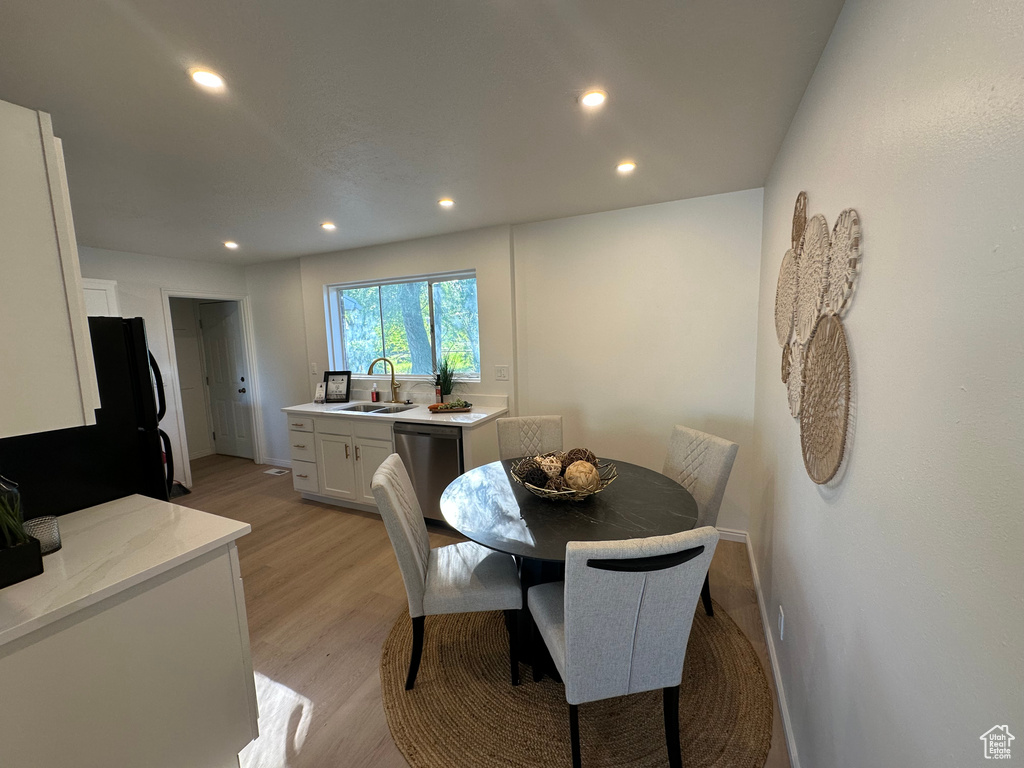Dining area featuring recessed lighting and light wood-type flooring