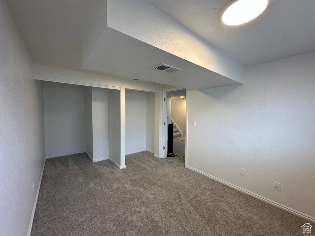 Finished basement with carpet and stairs