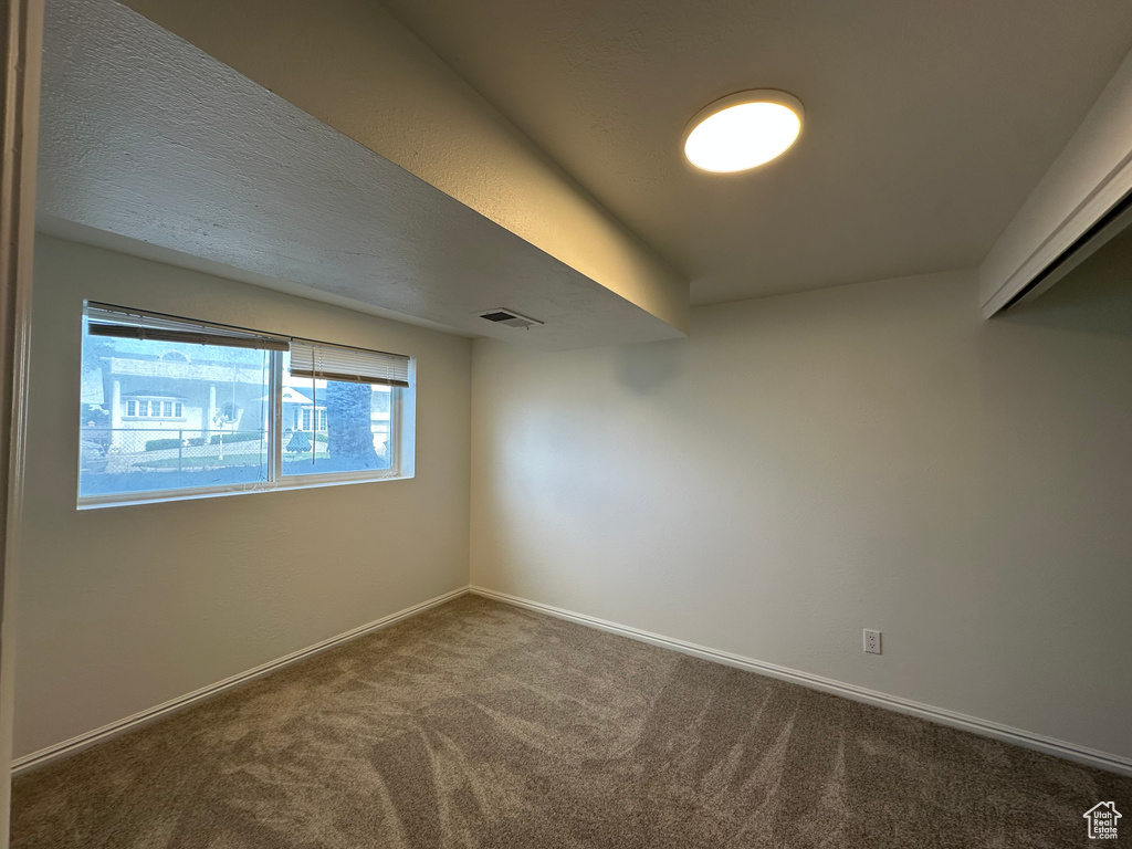 Empty room with carpet and baseboards