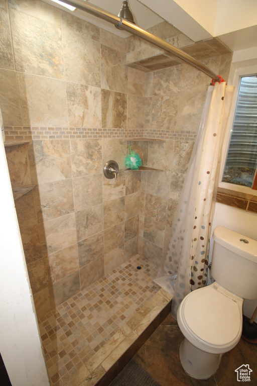 Bathroom featuring a stall shower and toilet